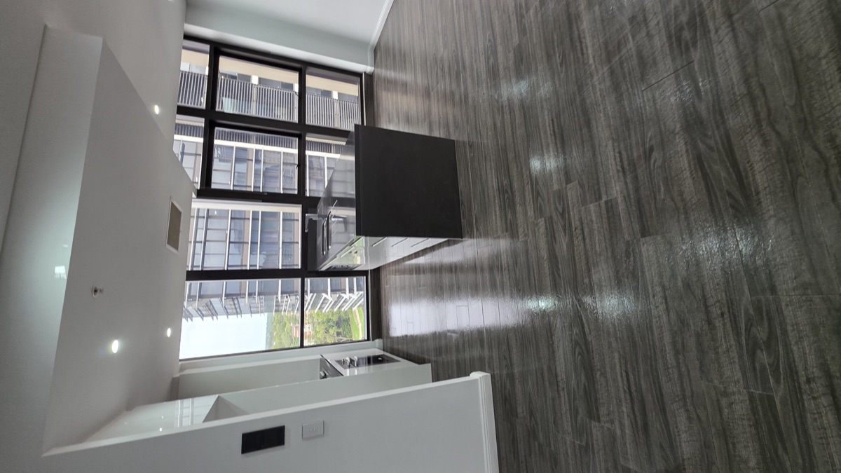 Open plan living and kitchen island with city view after end of lease clean